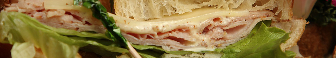 Eating Sandwich at Cane A Sucre Gourmet Sandwiches & Salads restaurant in North Miami, FL.